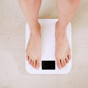 Patient on scale during weight management consultation at Westbroek Family Medicine